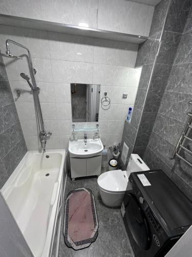 a bathroom with a tub and a toilet and a sink at Heart of Samarkand, main center in Samarkand