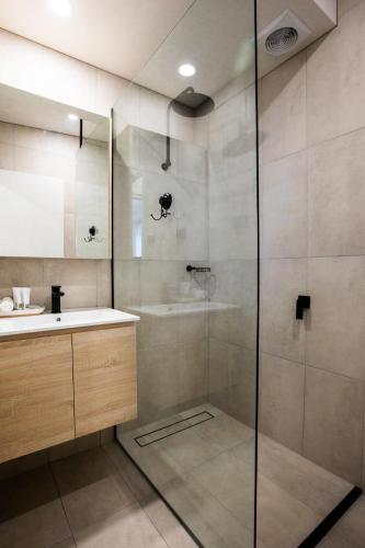 a bathroom with a shower and a sink at Adina Lodge Holiday Apartments in Bright