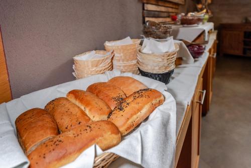 a group of loaves of bread on a table at Hotel Dolomiti Chalet in Vason