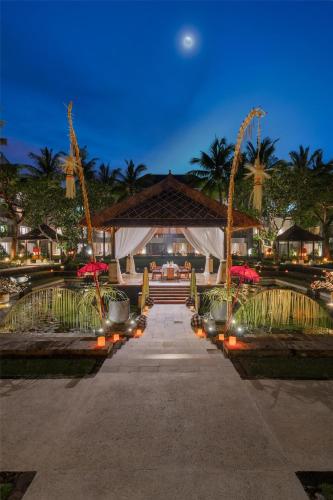 a pathway leading to a building with a moon in the sky at Conrad Bali in Nusa Dua