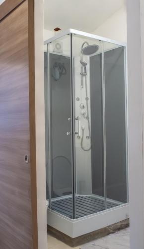a shower with a glass door in a bathroom at Résidence Victoria in Mamoudzou