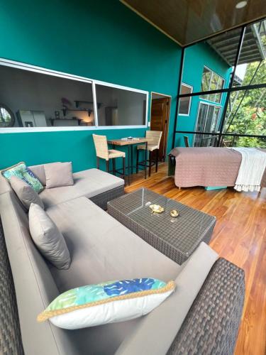 a living room with a couch and a table at The Emerald Haven in Parrita