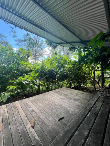 a wooden picnic table with a roof on top of it at The Emerald Haven in Parrita