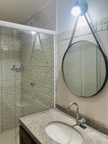 a bathroom with a sink and a mirror at Petit Thay Home in Cumbuco