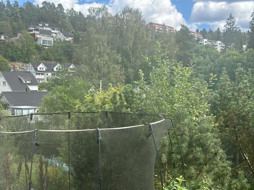 a batting cage with trees and houses in the background at Nordtrand Oslo Valley in Oslo