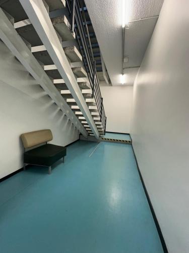 an empty hallway with a bench in a room at Tallinn Airport Stay in Tallinn