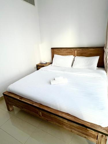 a bedroom with a large bed with a wooden frame at Reem Island, Unique furnished one bedroom with amazing seaview in Abu Dhabi