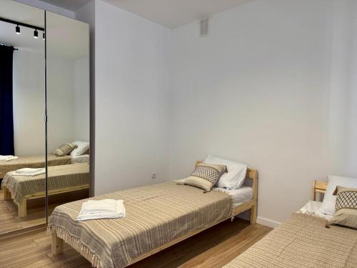 Ένα ή περισσότερα κρεβάτια σε δωμάτιο στο Apartament Kochanowskiego