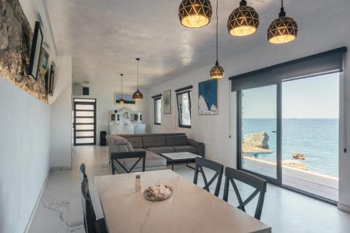 a living room with a table and a couch and the ocean at Art residence villa in Bar