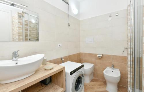a bathroom with a sink and a washing machine at Amazing Home In Giungano in Giungano