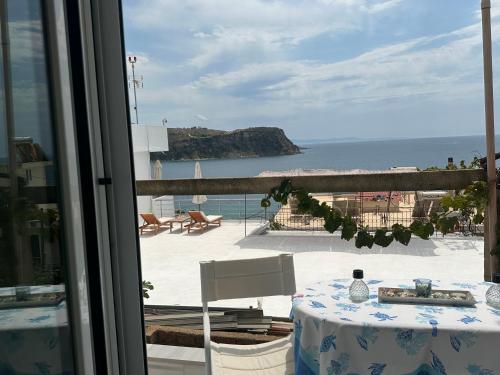 a room with a table and a view of the ocean at Joannas Stefaneli House in Himare