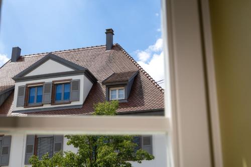 a house is seen through a window at Villa Diana in Molsheim