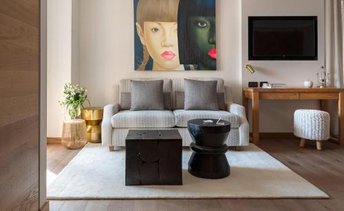 a living room with a couch and a painting at Esplanade Tergesteo - Luxury Retreat in Montegrotto Terme