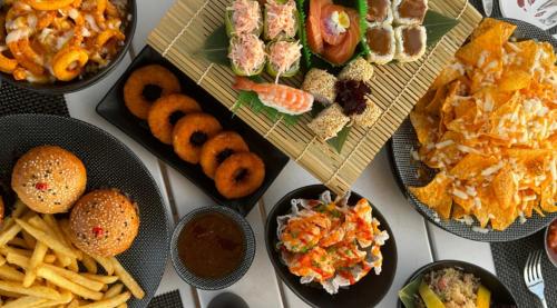 a table topped with plates of different types of food at Lancaster Eden Bay in Beirut