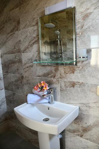 a bathroom with a sink and a mirror at Under the Buknari Sun in Kobuleti