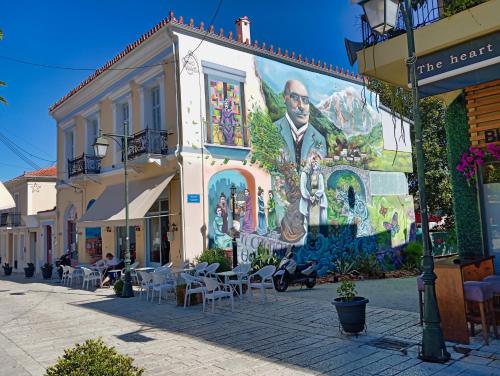 a building with a large mural on the side of it at Akrata Golden Beach House 2 in Aíyira