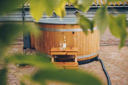 a large wooden tub sitting on top of a brick floor at Veluwepark de Bosgraaf in Apeldoorn