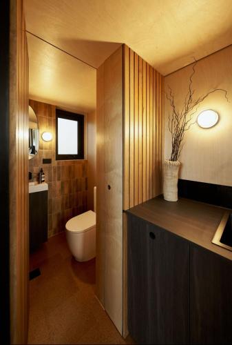 a bathroom with a toilet and a sink at Nestled Cabins in Verdun