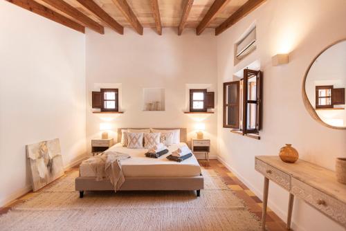 a bedroom with a bed and a large mirror at Las Rocas in Fornalutx