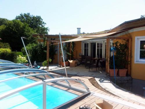 a house with a swimming pool in a yard at Sternhaus - Appartement am Kurpark in Bad Schallerbach