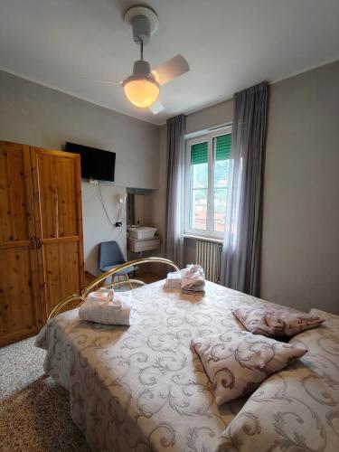 a bedroom with a large bed with pillows on it at Locanda di Bivigliano in Bivigliano