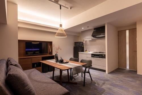 a living room with a couch and a table at Hotel TOKI 季 in Tokyo