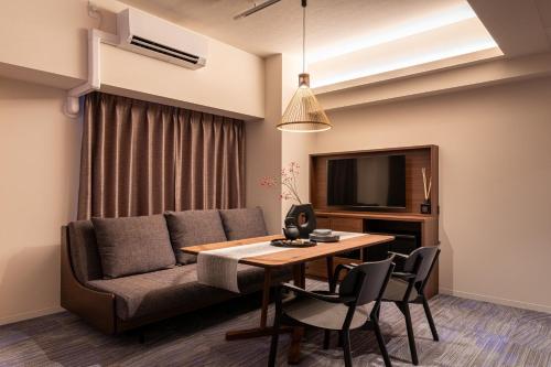 a living room with a couch and a table at Hotel TOKI 季 in Tokyo