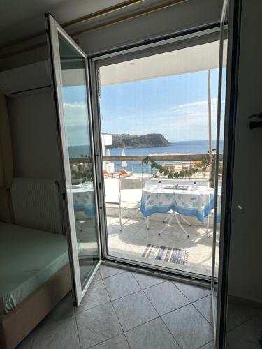 a balcony with a table and a view of the ocean at Joannas Stefaneli House in Himare