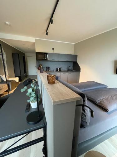 a kitchen with a counter and a bed in a room at Exklusives Wohnen im historischen Wasserturm dem Highlight von Delitzsch WE214 in Delitzsch
