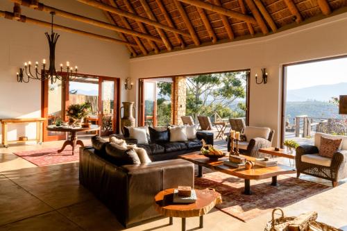 a living room with a couch and a table at Tamodi Estate in Plettenberg Bay
