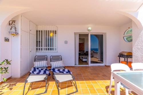 a living room with chairs and a table at SUENO by the Sea in Dehesa de Campoamor