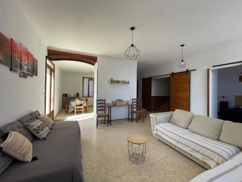 a living room with a couch and a table at Évasion ensoleillée avec jacuzzi à Cazedarnes in Cazedarnes