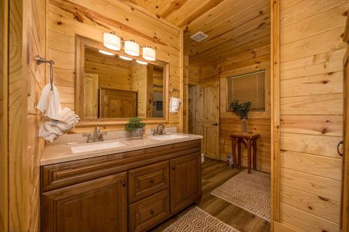 a bathroom with a sink and a mirror at Tridents Creek by American Patriot Getaways in Rocky Grove