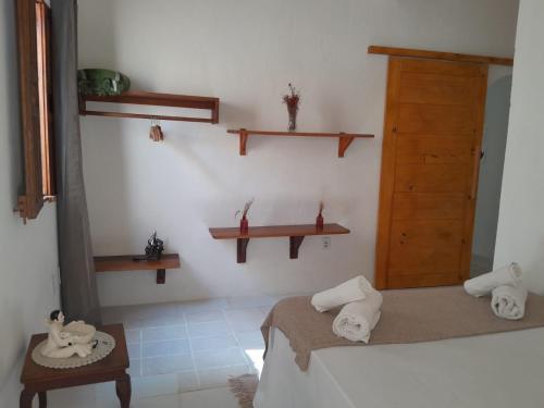 a room with two beds and shelves on the wall at Casa da Cristina in Trancoso