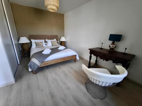 a bedroom with a bed and a bath tub and a sink at La Maison de l'Aqueduc in Cournanel