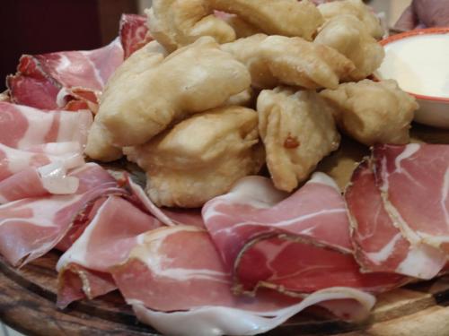 a plate of food with meat and other foods at Locanda di Bivigliano in Bivigliano
