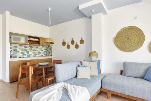 a living room with a couch and a table at Apartamentos Castaví in Es Pujols