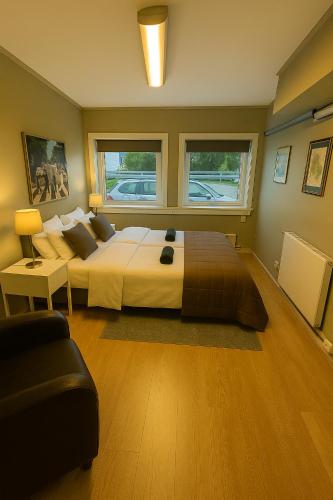 a bedroom with a large bed and a couch at The Cozy Oslo Stay in Oslo