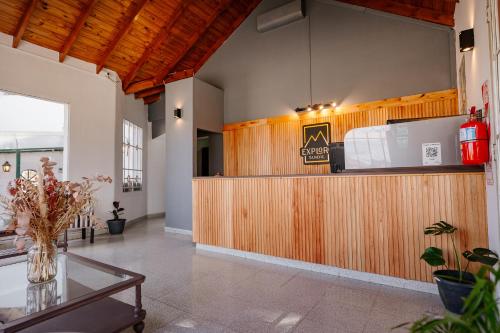 a lobby with a wooden counter and a table at Apart Hotel Explora Tandil in Tandil
