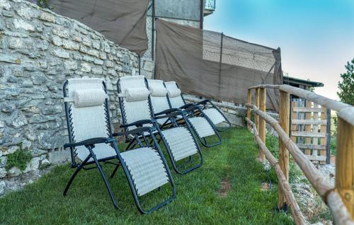a group of chairs sitting in the grass at Amazing Home In Castelletta With Wifi in Precicchie