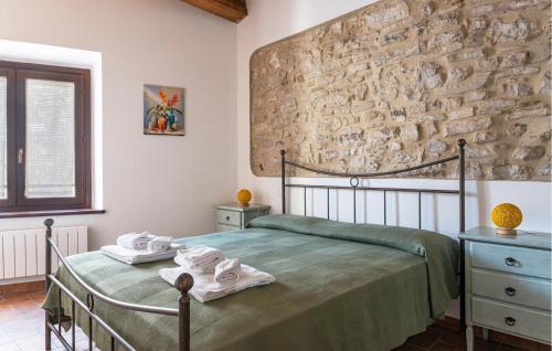 a bedroom with a bed and a stone wall at Amazing Home In Castelletta With Wifi in Precicchie
