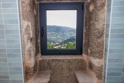 a window in a bathroom with a view of a city at Quinta Cerca da Milhera - Unique Experiences by LuxiStay in Ponte da Barca
