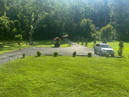 a car parked on a road in a field at Log Cabin in the Field in Huntington