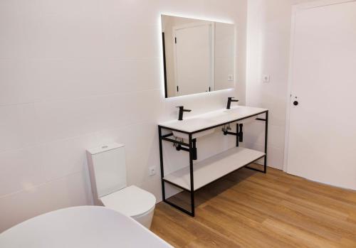 a bathroom with a sink and a toilet at Quinta Cerca da Milhera - Unique Experiences by LuxiStay in Ponte da Barca