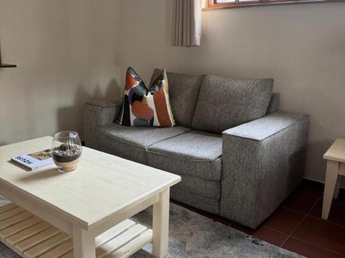 a living room with a couch and a coffee table at Rivonia Garden Suites in Johannesburg