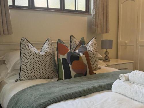 two beds with pillows on them in a bedroom at Rivonia Garden Suites in Johannesburg
