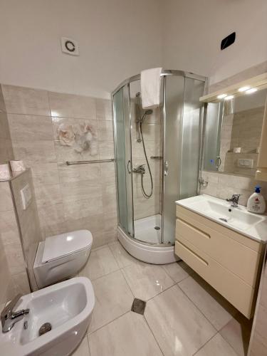 a bathroom with a shower and a toilet and a sink at Villa Gjoni in Kalmet