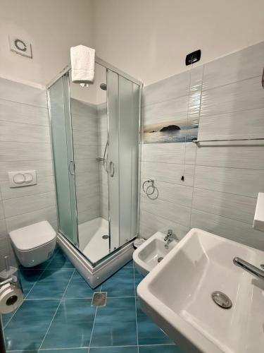 a bathroom with a shower and a sink and a toilet at Villa Gjoni in Kalmet