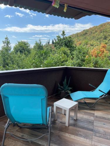 two chairs and a table on a balcony with a view at Salty Paws Medveja in Medveja