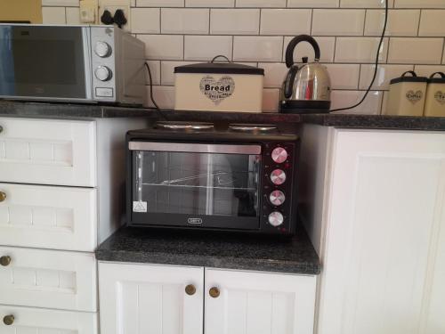 a microwave oven sitting on top of a kitchen counter at Rivonia Garden Suites in Johannesburg